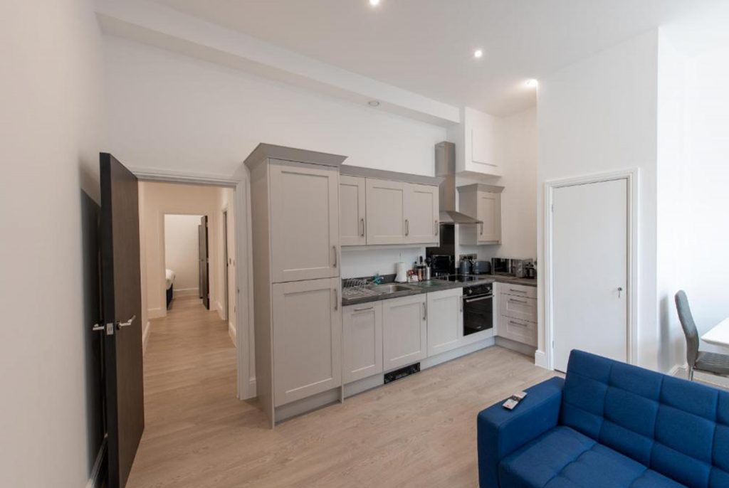 Bright, modern serviced apartment interior with a desk or dining table set up for work